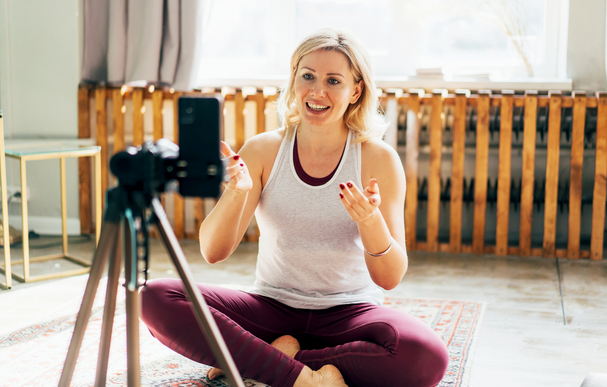 Woman filming workout at home